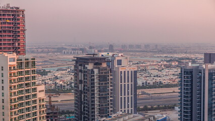 Luxury houses and villas near canal with towers aerial timelapse in Business Bay, Dubai, United Arab Emirates.