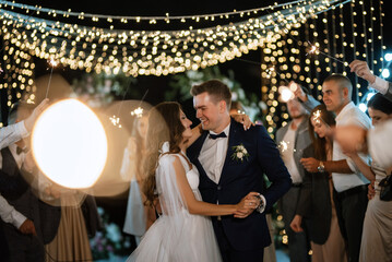 newlyweds at a wedding of sparklers