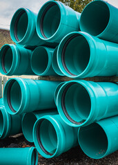 Stacks of green PVC water pipes. PVC water pipes used for construction.