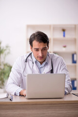 Young male doctor in telemedicine concept