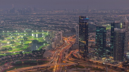 Naklejka na ściany i meble Big crossroad junction between JLT district and Dubai Marina intersected by Sheikh Zayed Road aerial day to night timelapse.