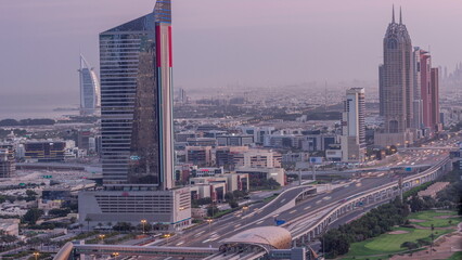 Obraz premium Aerial view of Sheikh Zayed Road in Dubai Internet City area night to day timelapse