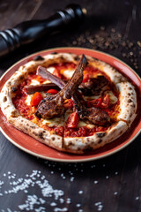 pizza with ribs on the black table