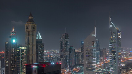 Skyscrapers on Sheikh Zayed Road and DIFC night timelapse in Dubai, UAE.