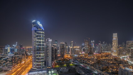 Fototapeta na wymiar Panorama showing Dubai's business bay towers aerial night timelapse. Rooftop view of some skyscrapers