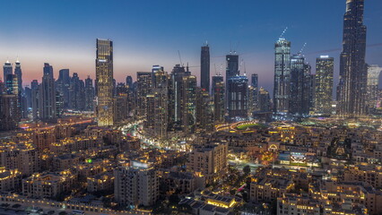 Dubai's business bay towers aerial day to night timelapse. Rooftop view of some skyscrapers