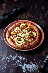 Pizza with avacado, jalapeno and pomegranate seeds