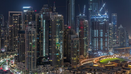 Futuristic aerial all night cityscape timelapse with illuminated architecture of Dubai downtown, United Arab Emirates.