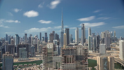 Panoramic skyline of Dubai with business bay and downtown district all day timelapse.