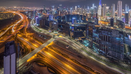 Fototapeta na wymiar Panorama showing skyline of Dubai with business bay and downtown district night timelapse.