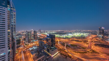 Aerial view of media city and al barsha heights district area day to night timelapse from Dubai marina.