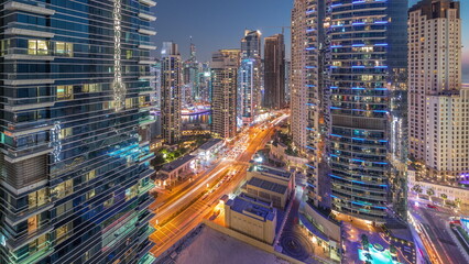 Fototapeta na wymiar Panoramic view of the Dubai Marina and JBR area and the famous Ferris Wheel aerial day to night timelapse