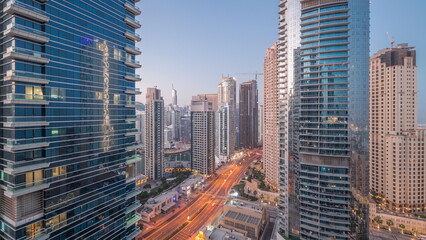 Obraz premium View of the Dubai Marina and JBR area and the famous Ferris Wheel aerial night to day timelapse