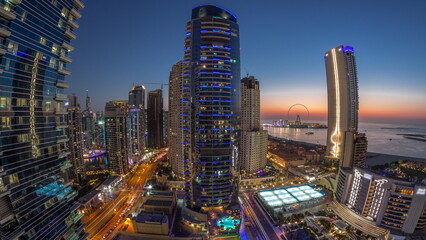 Panorama of the Dubai Marina and JBR area and the famous Ferris Wheel aerial day to night timelapse