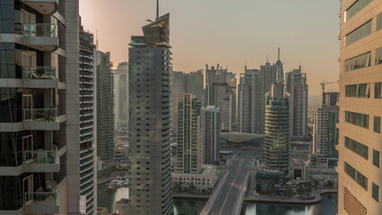 Aerial view on Dubai Marina skyscrapers and the most luxury yacht in harbor morning timelapse, Dubai, United Arab Emirates