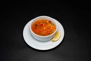 Soup in a bowl isolated black background