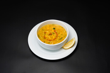 Soup in a bowl isolated black background