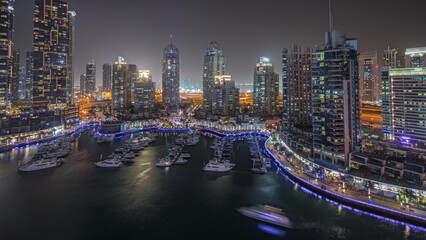 Fototapeta na wymiar Panorama showing luxury yacht bay in the city aerial night timelapse in Dubai marina