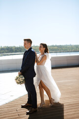 bride and groom first meeting on the roof of skyscraper