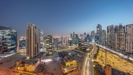 Fototapeta na wymiar Business Bay with modern towers residential development aerial panoramic day to night timelapse, Dubai