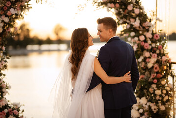 bride and groom against the backdrop of a yellow sunset