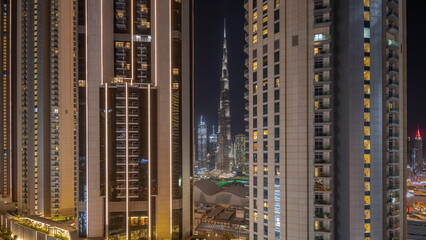 Fototapeta na wymiar Tallest skyscrapers in downtown dubai located on bouleward street near shopping mall aerial night timelapse.