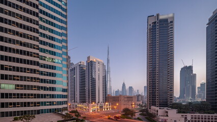 Obraz na płótnie Canvas Aerial panoramic view to Dubai downtown and difc skyscrapers night to day timelapse.