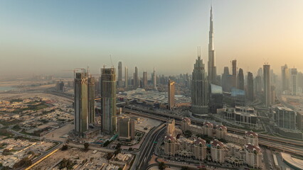 Fototapeta na wymiar Panorama showing aerial view of tallest towers in Dubai Downtown skyline and highway timelapse.