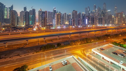 Naklejka premium Dubai marina tallest block of skyscrapers day to night timelapse.