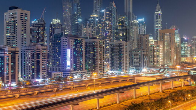 Dubai marina tallest block of skyscrapers day to night timelapse.