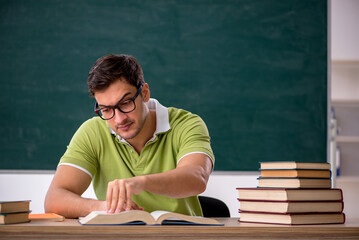 Young male student sitting in the classroom