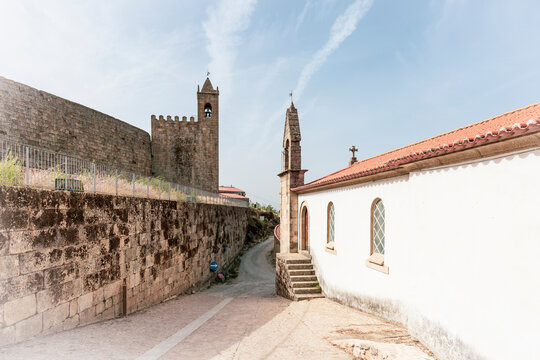 clock tower on the castle wall and the Church of Mercy in Penamacor, district of Castelo Branco, Beira Baixa, Portugal - October 2022