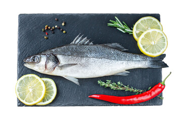 Fresh fish with spices and herbs on table in kitchen. Fresh sea bass.