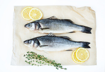 Fresh fish with spices and herbs on table in kitchen. Fresh sea bass.