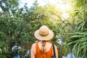 Adventure travel woman on vacation, looking into tropical forest, lake, swamp and enjoy her trip