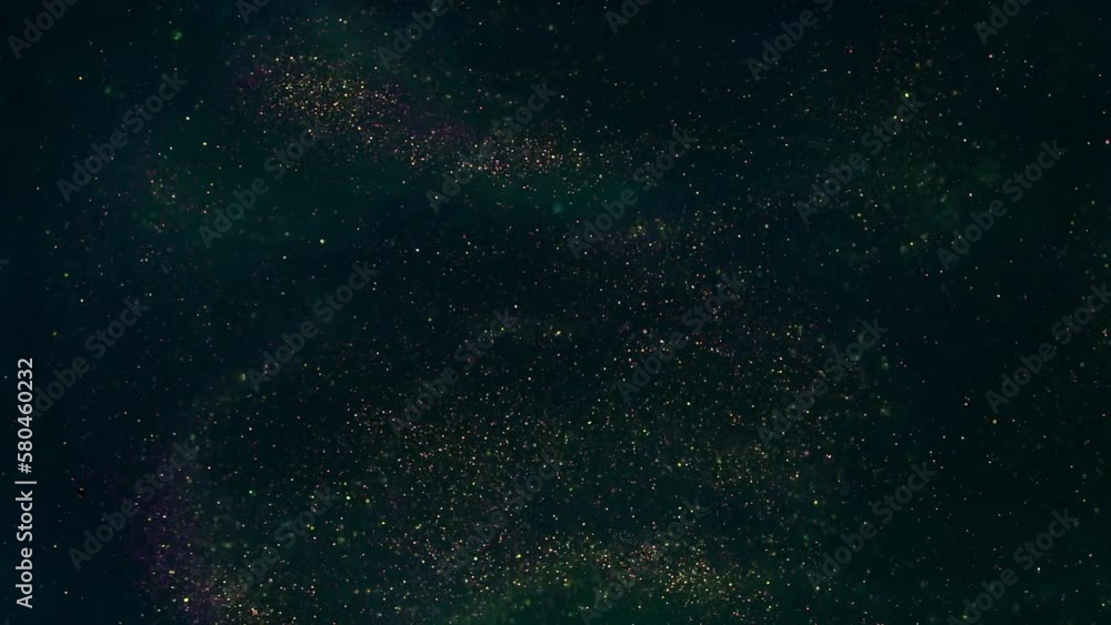 Wall mural a swirling stream of gold dust particles in a green liquid. slow motion of floating shimmering golde