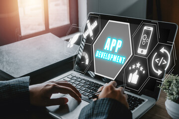 App development concept, Person hand using laptop computer with app development icon on virtual...