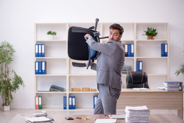 Young male employee working in the office