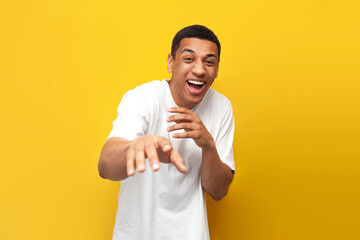 young funny guy african american in white t-shirt mocking and joking showing his hands to the camera