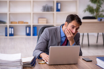 Young male employee working in the office