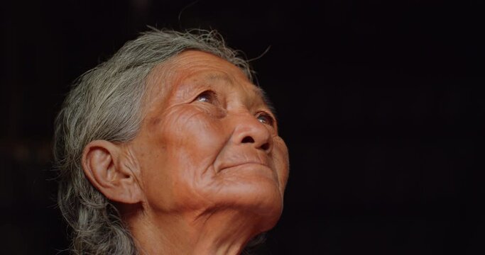 The Asian female farmer who is a poor elderly native looked up at the sky as though something had happened. Used in humanity, documentary, lonely person, environment, concepts, or movies.