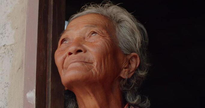 The Asian female farmer who is a poor elderly native looked up at the sky as though something had happened. Used in humanity, documentary, lonely person, environment, concepts, or movies.