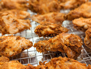 Chicken wings in a marinade on a baking sheet. Cooking chicken with spices in the oven.