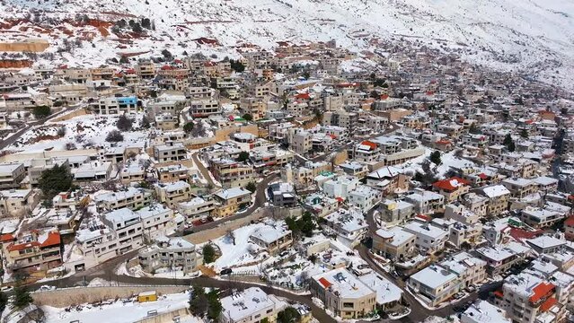 Hermon mountain and Majdal Shams houses covered with snow, Drone view