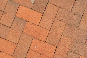 Red interlocking bricks on patio pavement walkway for pedestrians in public downtown city urban park land space