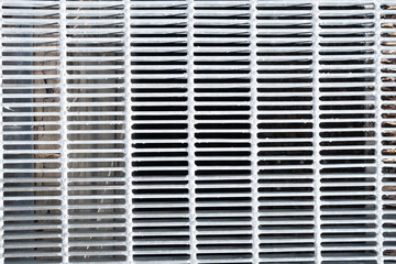 Steel grate with tight pattern of long thin strips to vent air from underground urban infrastructure