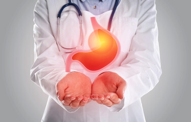 Treatment of heartburn and other gastrointestinal diseases. Doctor holding stomach illustration on...