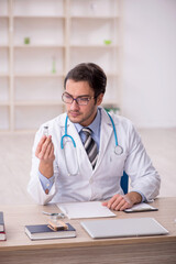 Young male doctor working in the clinic