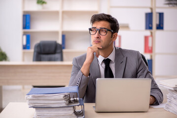 Fototapeta premium Young male employee working in the office