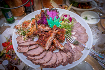 sliced grilled beef steak with green leaves salad on plate with cutlery